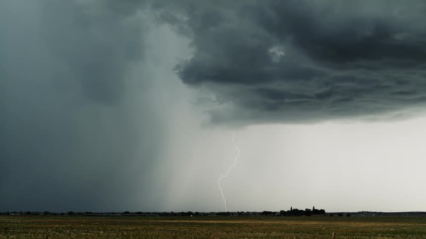 Lightning flashes across a dark and cloudy sky