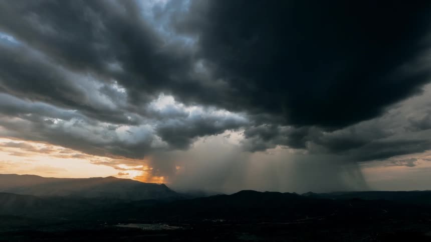 Dark clouds float over the mountains