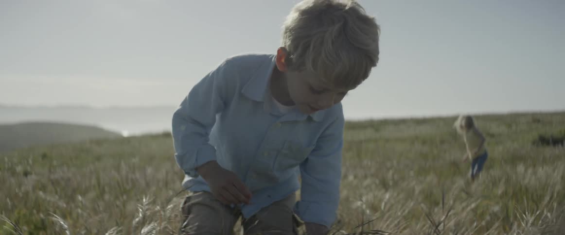 Boy and girl in a field of weeds