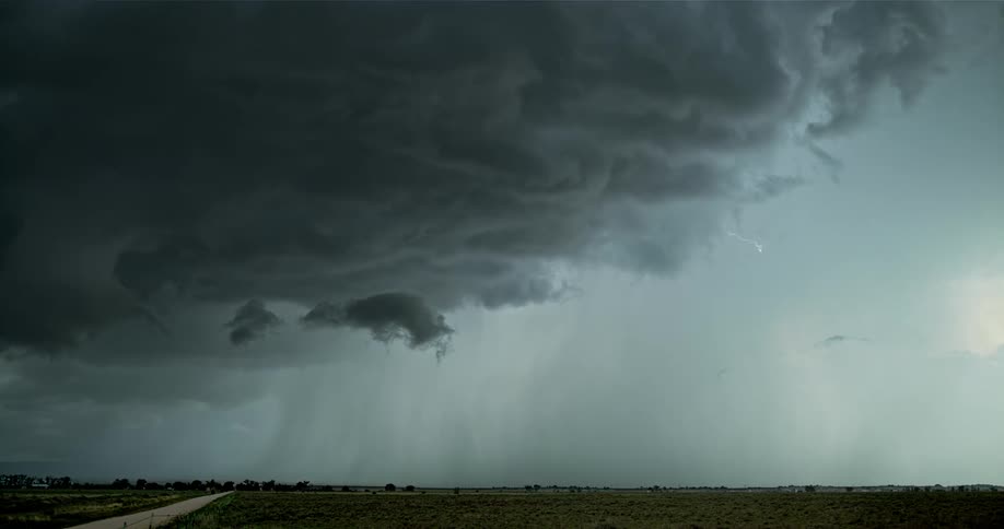 A storm brews over an open field