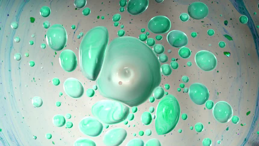 Green paint swirls and flows