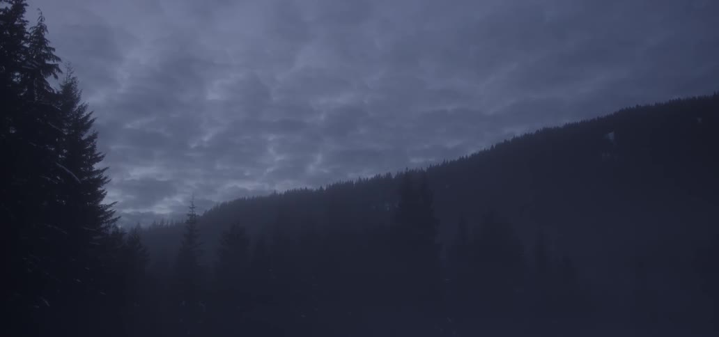 Clouds cluster over a mountain