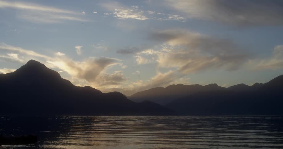 The water surface ripples and shimmers at sunset