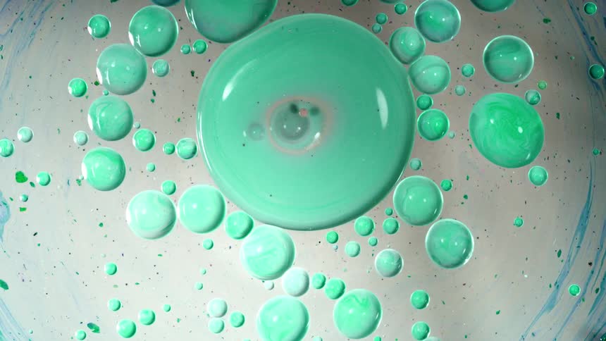 Green paint swirls and flows