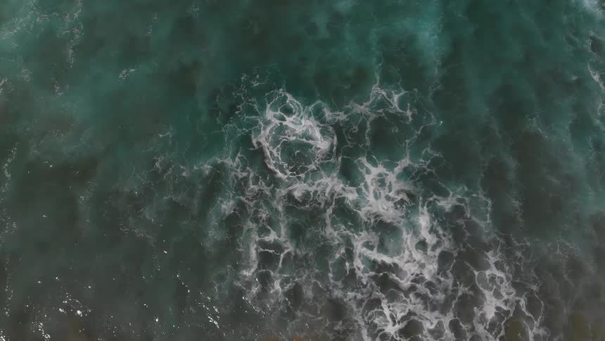 Foamy waves roll through the ocean