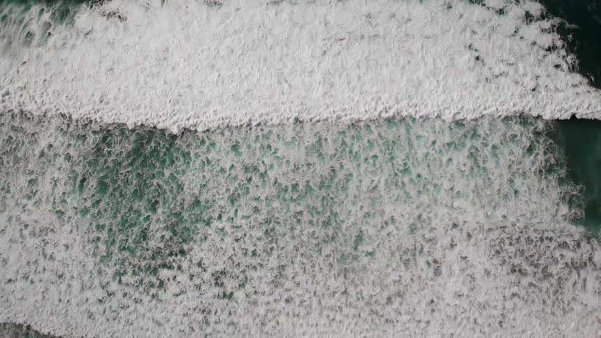Ocean waves wash ashore a beach