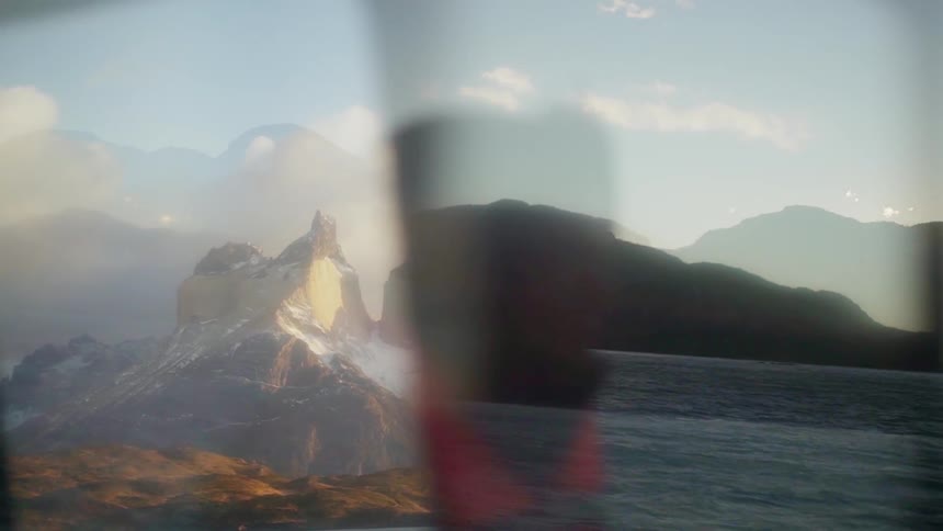 A man boats on a mountain lake