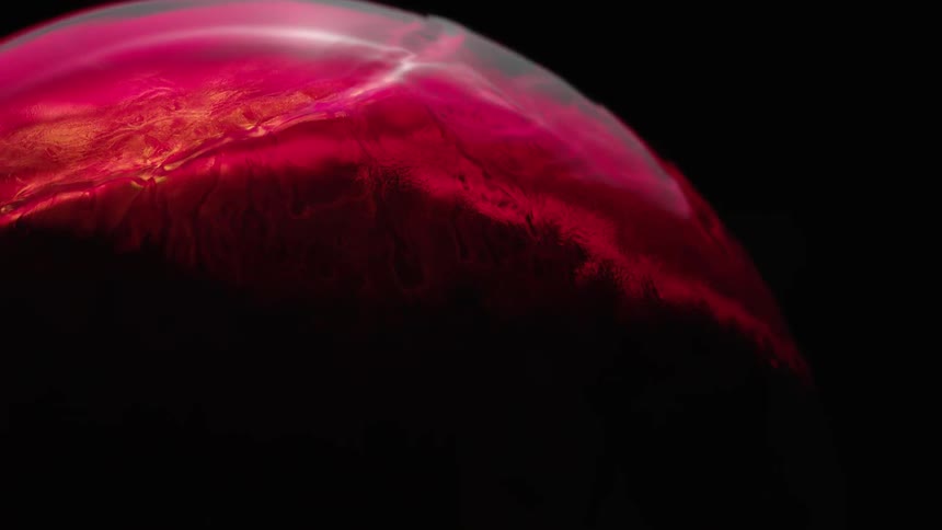 Red liquid spreads over a circular object