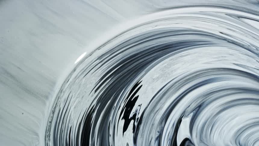 Black and white paint swirls and flows