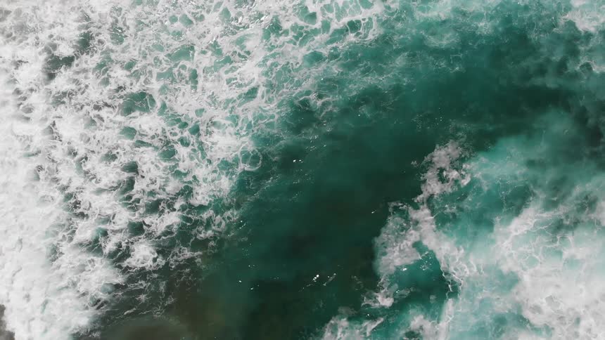 Frothy waves roll in to the shore