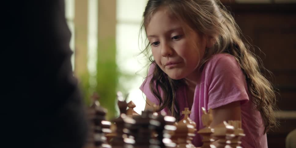 A girl plays chess