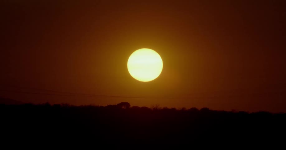 The sun sets over the horizon