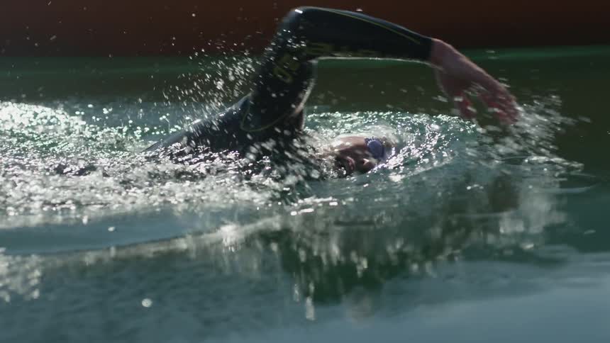 A man swims in a lake