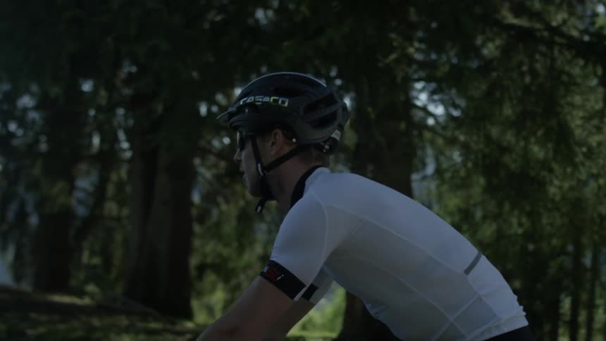 A bicyclist rides on a mountain road