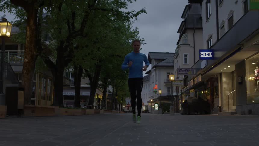 A man jogs on a city street