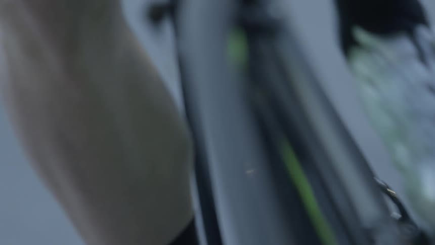 A person wearing white shoes is pedaling a bicycle