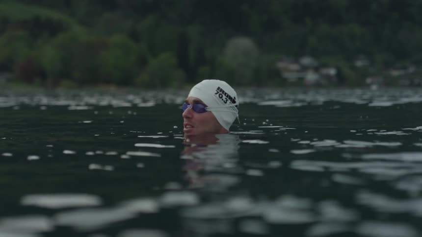 A man swims in a lake