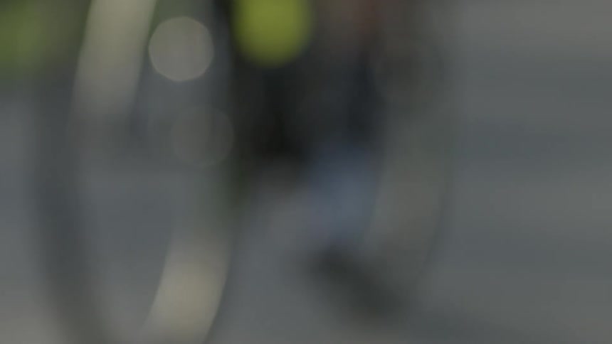 A person is riding a bicycle outside on a sunny day