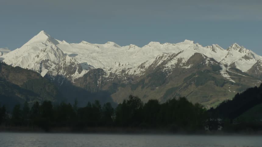The mountain range is capped with snow