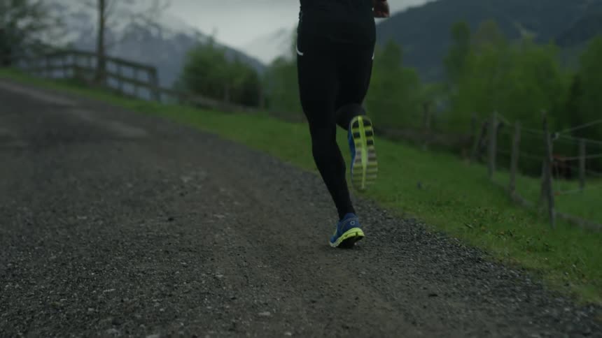 A person is running along a gravel road