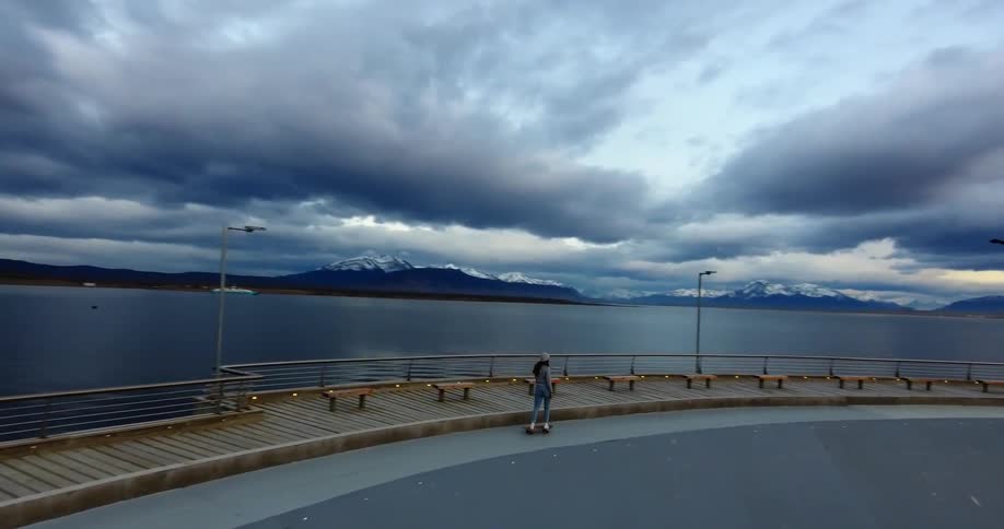 A skateboard rides by the water