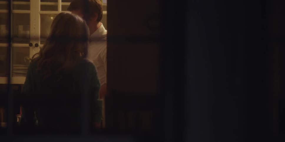 Man and woman standing indoors talking