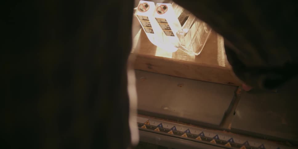 A man cuts a piece of wood