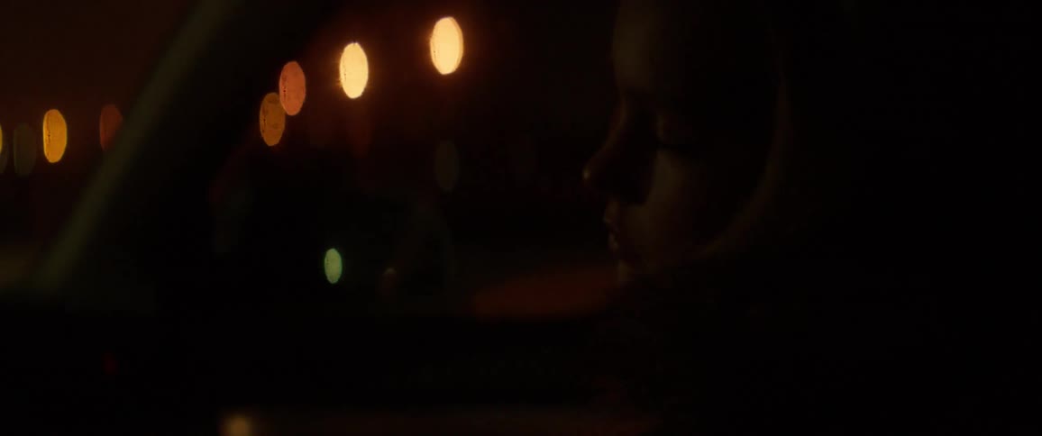 A girl is sleeping in the moving car at night