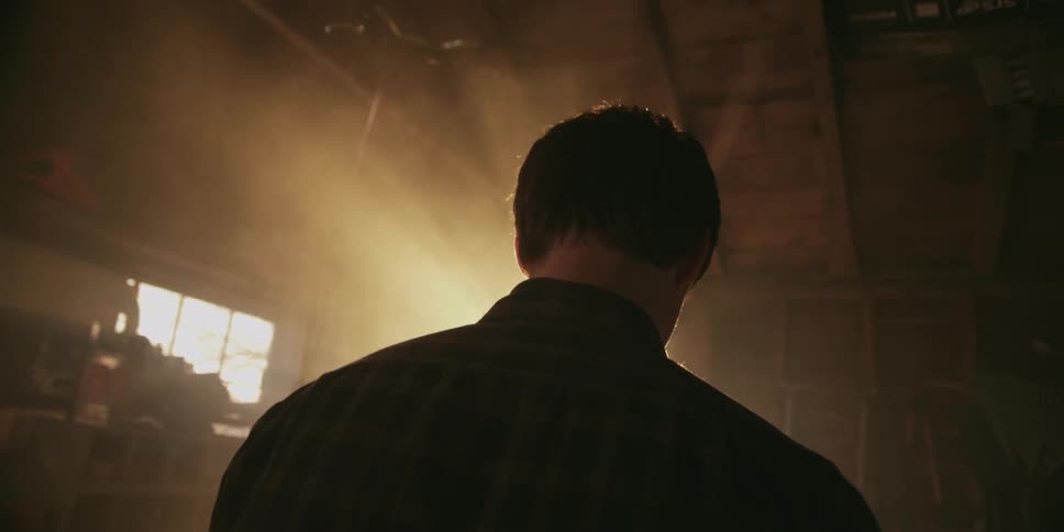 Man standing in a room looking down