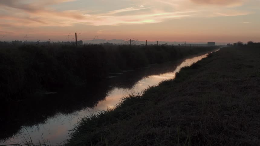 A dusk sky is being reflected in a flowing stream