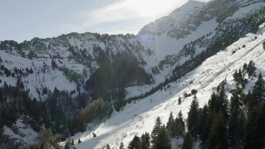 Sunlight shines over snowy mountains