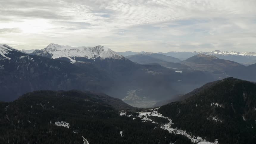 Sun shines through clouds over mountains
