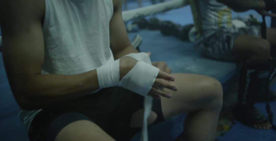 Boxers wrap their hands with athletic tape