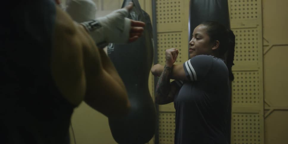 Woman instructs several students in a gym