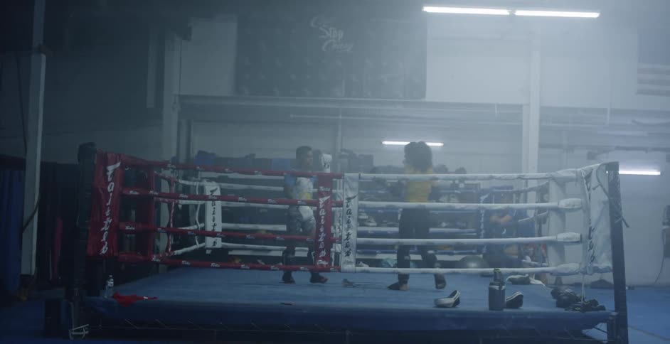 A man and woman box in a ring