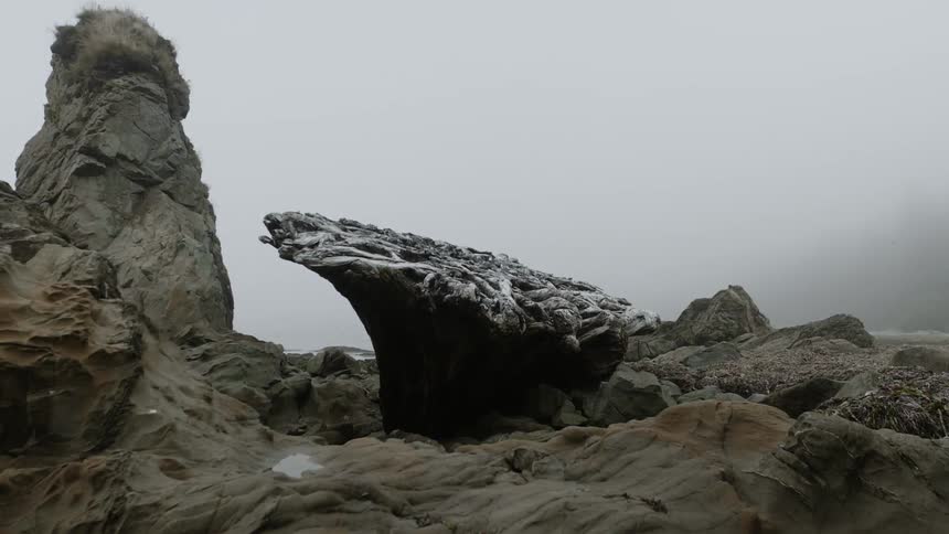 Mist floats above a rocky landscape