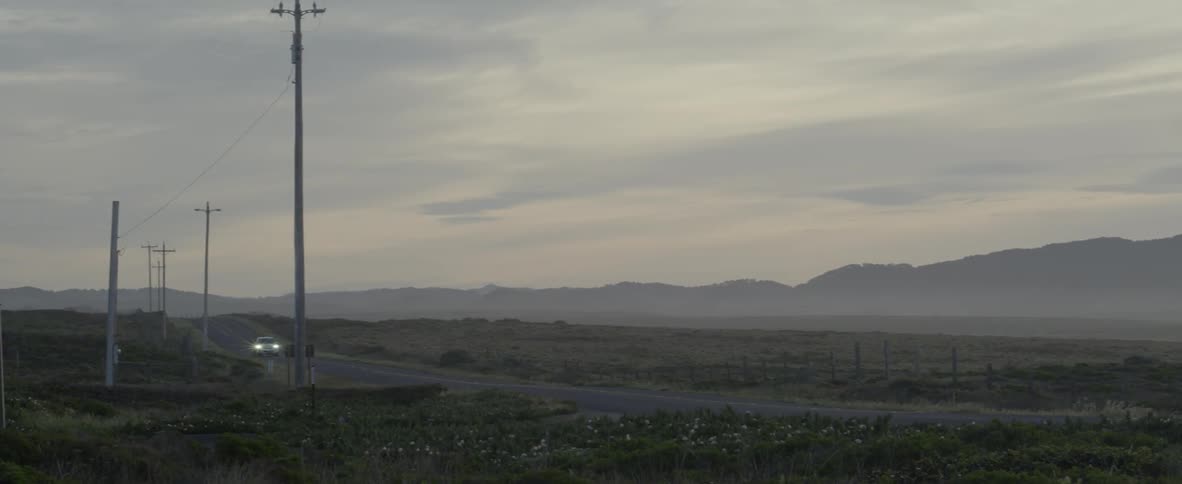 A car drives on a rural road