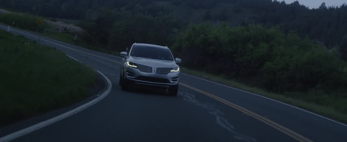 A car drives on a rural road