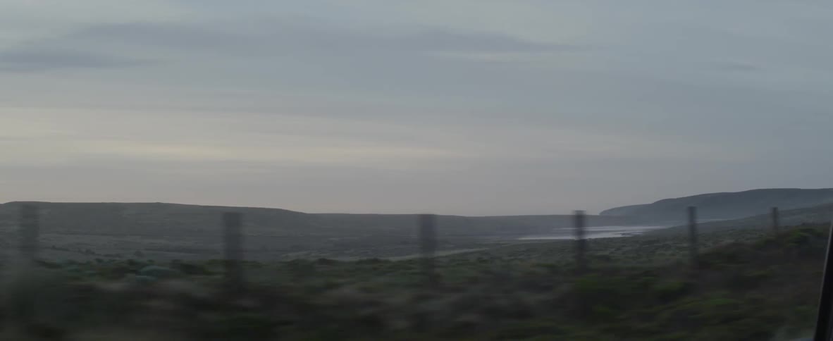 A car drives on a rural road