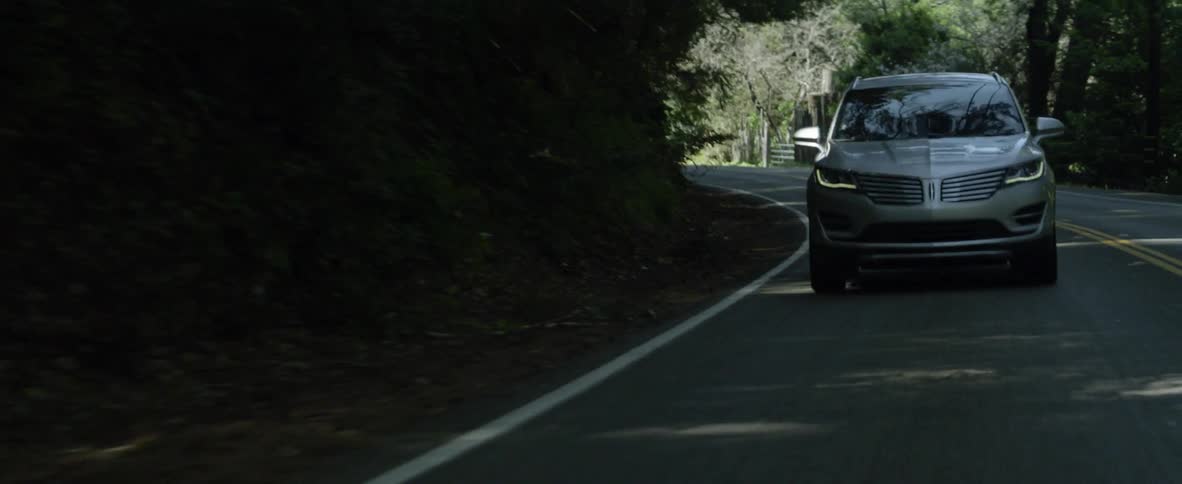 A car drives on a rural road
