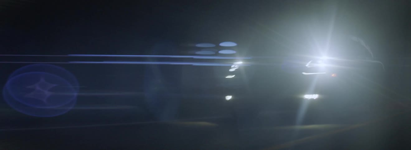 Vehicle drives down a road at night