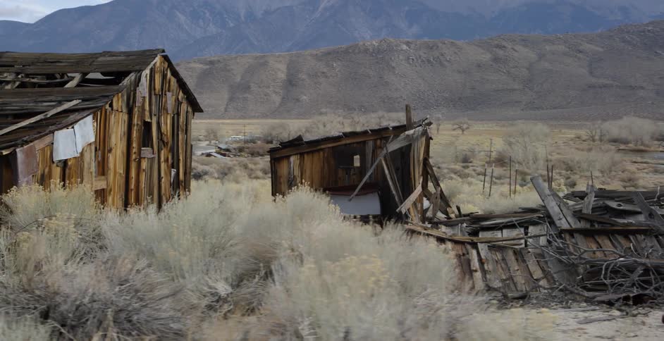 Collapsed cabin and out buildings in the brush