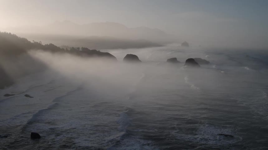 Sunlight shines over ocean waves on a beach