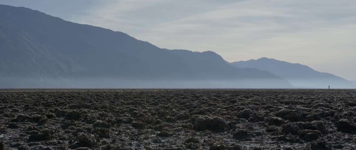 Bumpy plains with mountains in the background