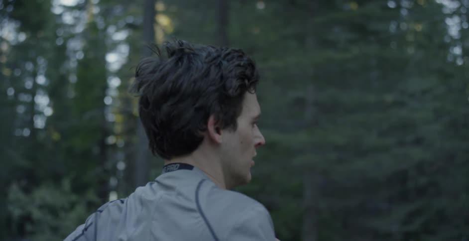 A man jogs in a forest