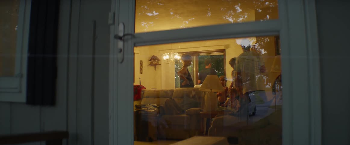 Looking through the front door of a house with a family inside
