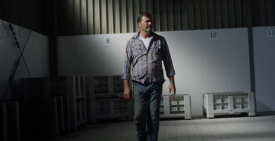 A man walks inside a warehouse building