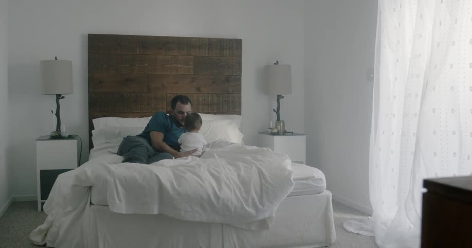 A man is in the bed with a child