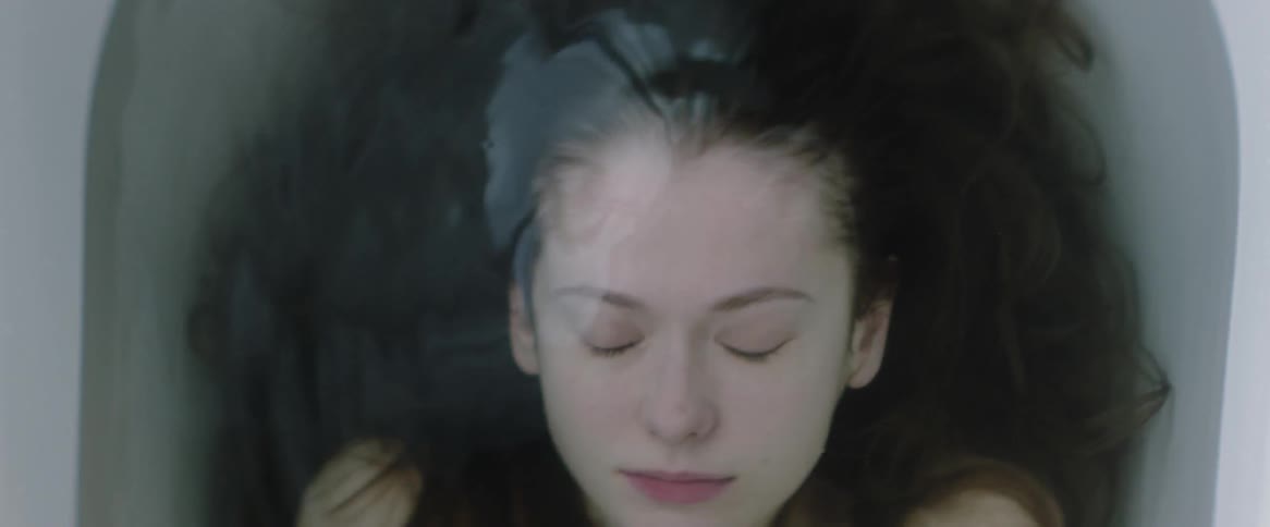 A woman is submerged in a bathtub