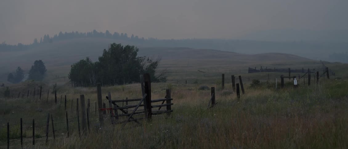 The sun sets over a  rural ranch